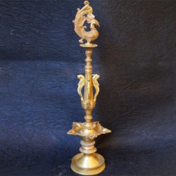 Traditional brass deepa stand with peacock on top